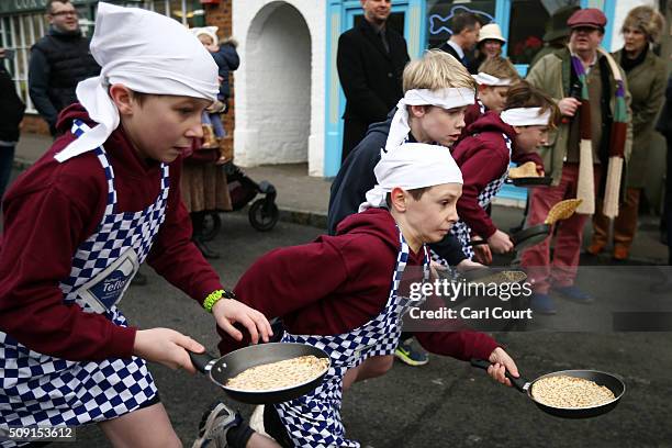 Schoolchildren take part in a pancake race on February 9, 2016 in Olney, England. On Shrove Tuesday every year the ladies of Olney, Buckinghamshire...