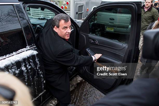 Republican presidential candidate New Jersey Governor Chris Christie exits his SUV outside the polling place at Webster School February 9, 2016 in...