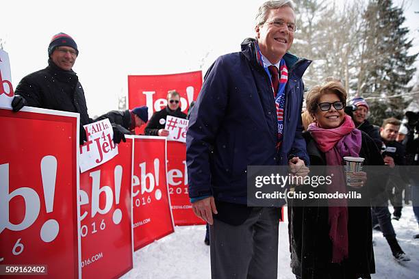 Republican presidential candidate Jeb Bush and his wife Columba Bush stop to pose for a photograph while thanking supporters outside the polling...