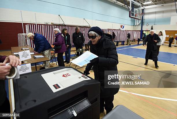 An elderly woman casts her ballot for the first US presidential primary at a school gym in Concord, New Hampshire, on February 9, 2016. New Hampshire...