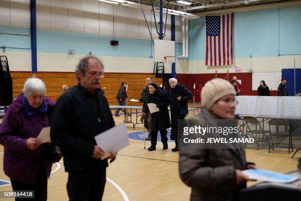 Local residents cast their ballots for the first US presidential primary at a school gym in Concord, New Hampshire, on February 9, 2016. New...