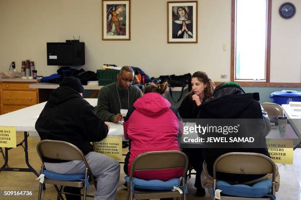 Local residents get registered to vote for the first US presidential primary at a church in Concord, New Hampshire, on February 9, 2016. New...