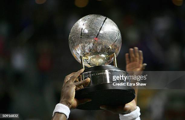 Ben Wallace of the Detroit Pistons holds up the Eastern Conference championship trophy after defeating the Indiana Pacers in Game six of the Eastern...