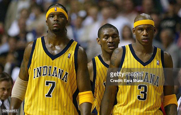Jermaine O'Neal, Ron Artest and Al Harrington of the Indiana Pacers look on after Artest committed a flagrant foul on Richard Hamilton of the Detroit...