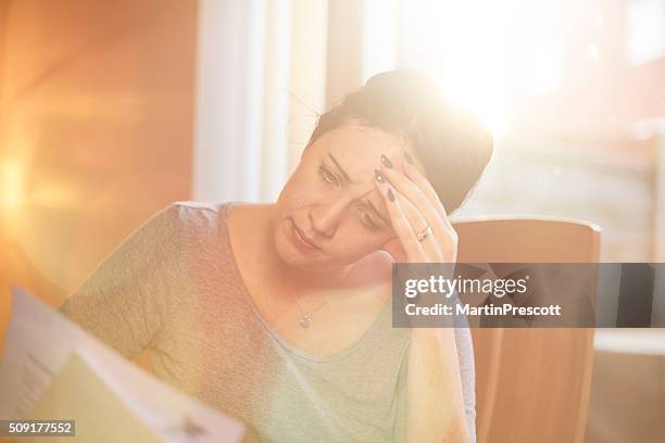 young woman struggling with the bills - bailiff stock pictures, royalty-free photos & images