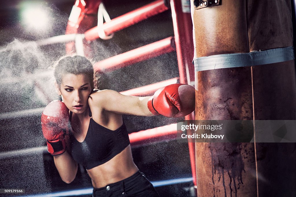 Female boxer training with a punching bag