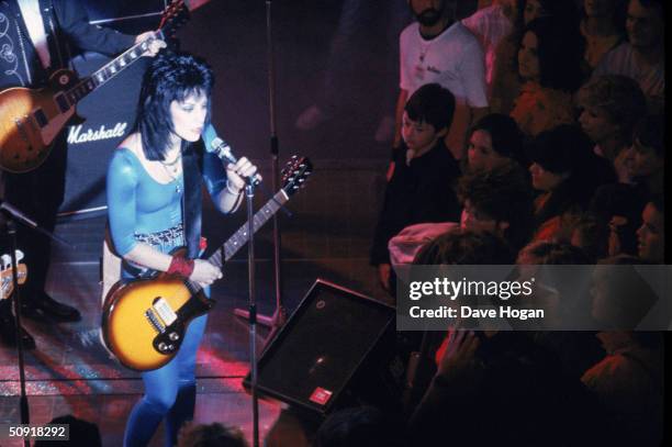 American rocker Joan Jett performs for a youthful audience, 1984.