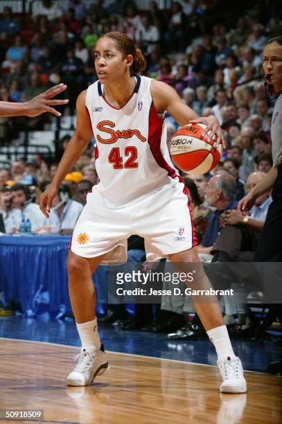 Nykesha Sales of the Connecticut Sun dribbles the ball against the Phoenix Mercury during the game on May 22, 2004 at the Mohegan Sun Arena in...