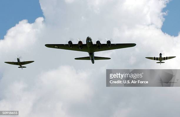 In this handout image provided by the U.S. Air Force, the "Sally B" B-17 Flying Fortress is escorted by Royal Air Force Spitfires as they perform...