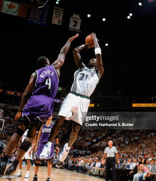 Kevin Garnett of the Minnesota Timberwolves puts a shot up against Chris Webber of the Sacramento Kings in Game Seven of the Western Conference...