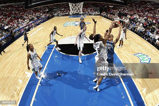 Aiysha Smith of the Washington Mystics shoots over Stacey Lovelace-Tolbert of the Minnesota Lynx during the game at the Target Center on May 28, 2004...