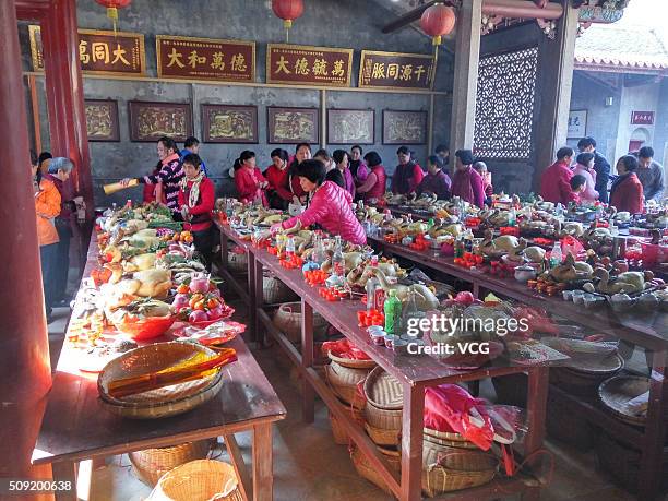 Villagers arrange grand feast to worship ancestors on first day of new Year of Monkey at Dawan Village of Pingshan New Area on February 9, 2016 in...