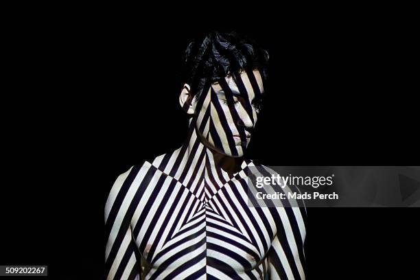 young man covered by abstract patterns of light - black and white photo stock pictures, royalty-free photos & images