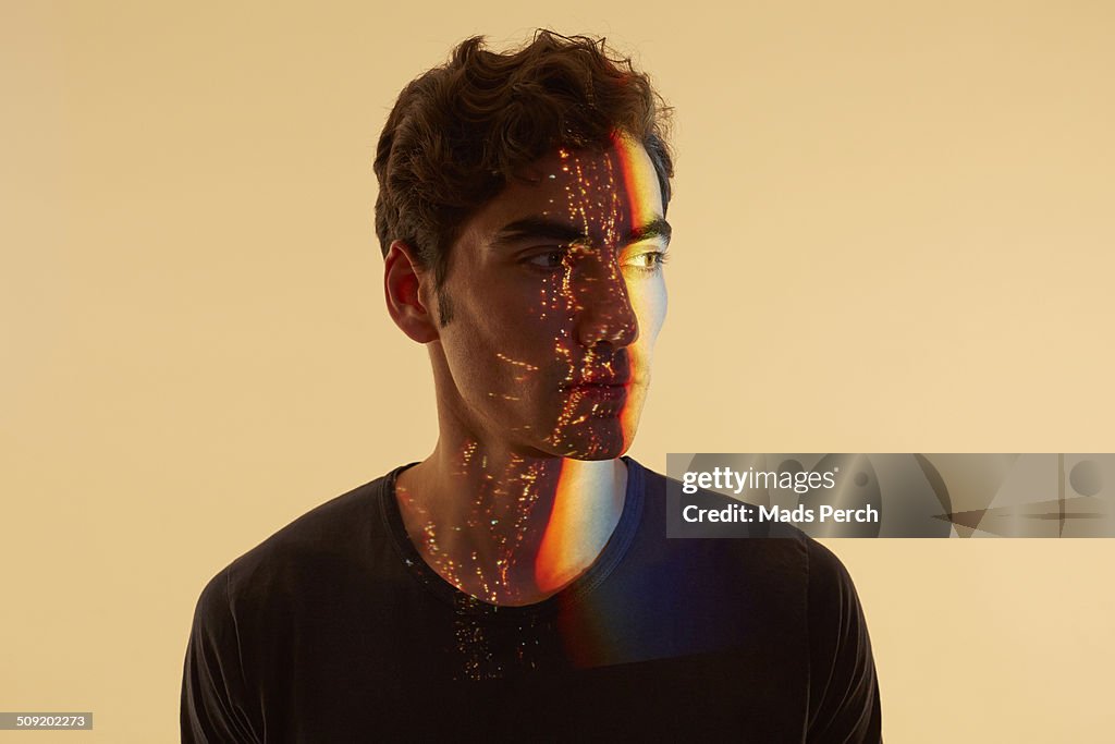 Young Man with Cityscape Reflected on to him