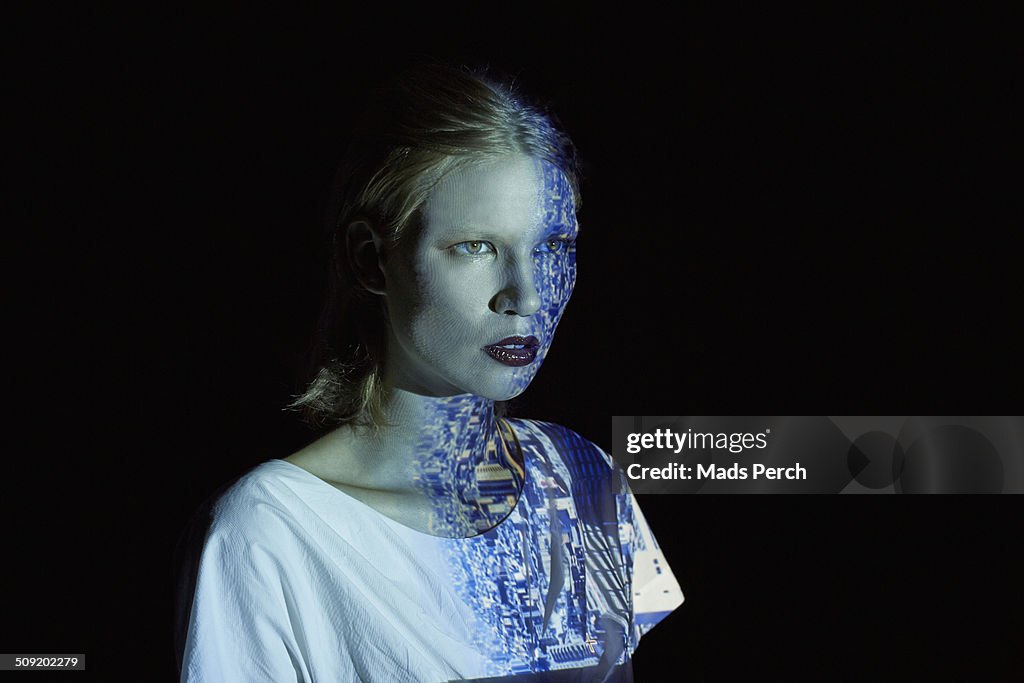 Young Woman Covered in Reflection of a Cityscape