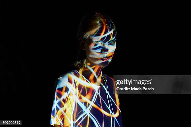 Young Woman covered in colorful lights