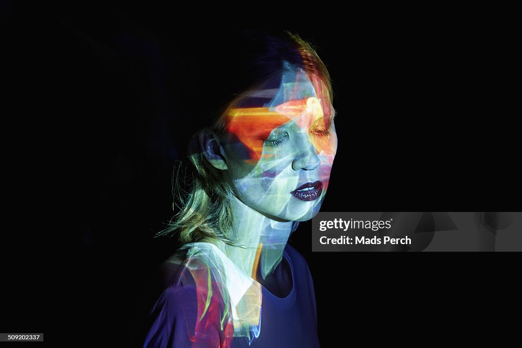 Young Woman with Multicolored Light in her Face