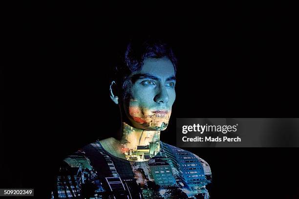 young man with cityscape projected on to him - projection stock-fotos und bilder