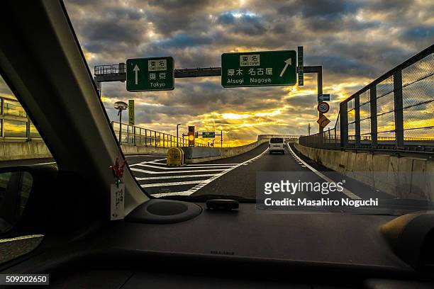 driving at the expressway interchange under the morning sun rays - ebina city stock pictures, royalty-free photos & images