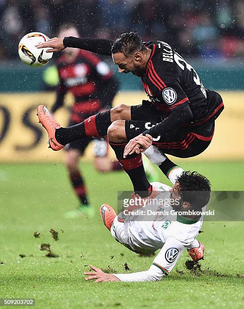 Santiago Garcia of Werder Bremen challenges Karim Bellarabi of Bayer Leverkusen during the DFB Cup Quarter Final match between Bayer Leverkusen and...