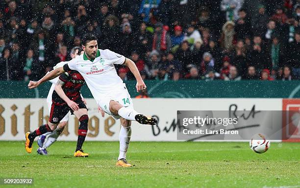 Claudio Pizarro of Werder Bremen scores their second goal from the penalty spot during the DFB Cup Quarter Final match between Bayer Leverkusen and...