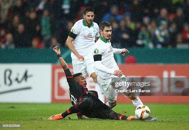 Wendell of Bayer Leverkusen fouls Fin Bartels of Werder Bremen for a penalty and is sent off during the DFB Cup Quarter Final match between Bayer...