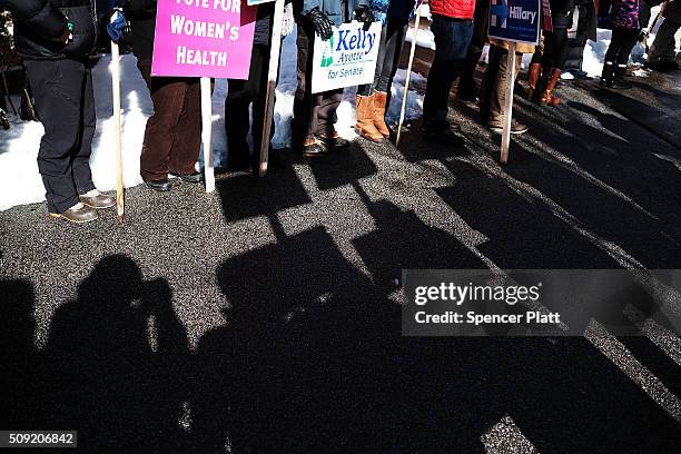 The shadows of supporters of Democratic presidential candidate Bernie Sanders reflect on the ground before his arrival into downtown Concord on...