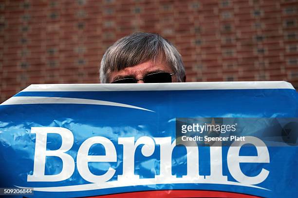 Supporter of Democratic presidential candidate Bernie Sanders waits for his arrival into downtown Concord on Primary Day on February 9, 2016 in...
