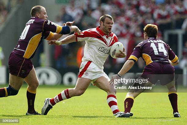 Keiron Cunningham of St.Helens is tackled by Huddersfield's Jim Gannon and Stuart Jones during the Powergen Challange Cup Semi Final match between...