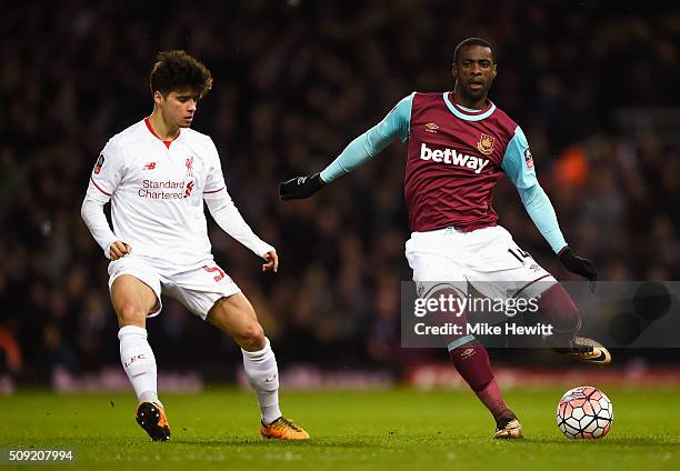 Pedro Mba Obiang of West Ham United is watched by Joao Carlos Teixeira of Liverpool during the Emirates FA Cup Fourth Round Replay match between West...