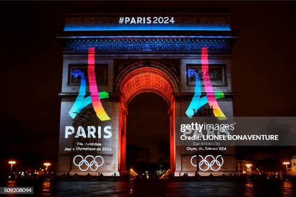 The campaign's official logo of the Paris bid to host the 2024 Olympic Games is seen on the Arc de Triomphe in Paris on February 9, 2016. AFP PHOTO /...