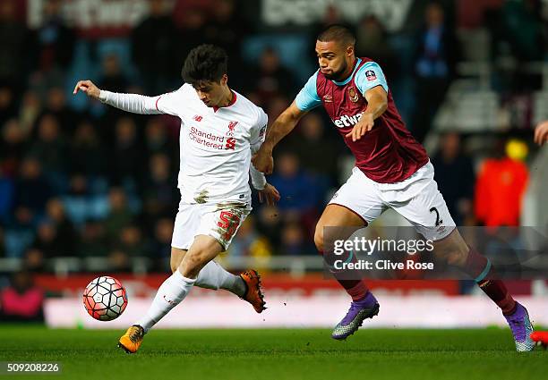 Joao Carlos Teixeira of Liverpool evades Winston Reid of West Ham United during the Emirates FA Cup Fourth Round Replay match between West Ham United...