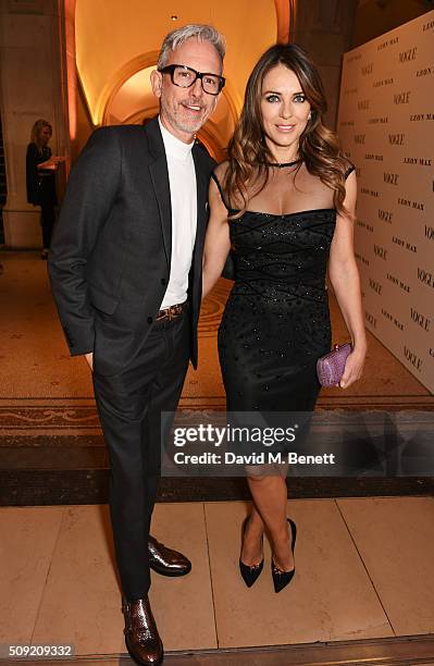 Patrick Cox and Elizabeth Hurley attend a private view of "Vogue 100: A Century of Style" hosted by Alexandra Shulman and Leon Max at the National...