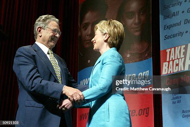 Philanthropist George Soros greets U.S. Senator Hillary Clinton after she introduced him at the Take Back America Conference June 3, 2004 in...