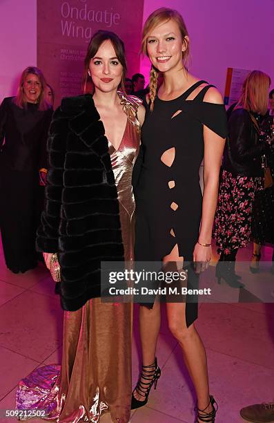 Dakota Johnson and Karlie Kloss attend a private view of "Vogue 100: A Century of Style" hosted by Alexandra Shulman and Leon Max at the National...