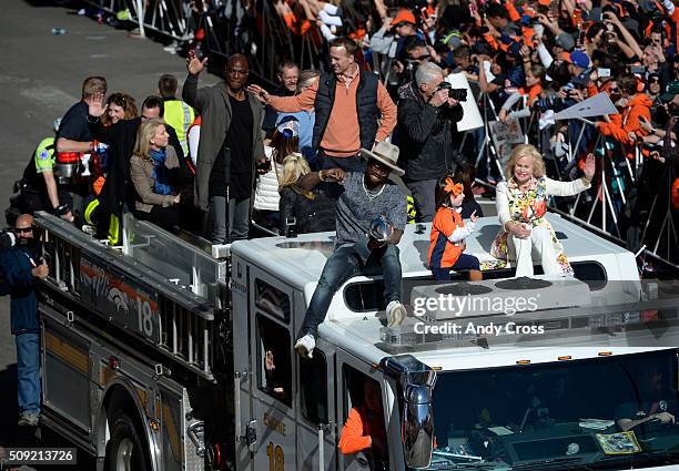 February 09: Denver Broncos DeMarcus Ware, QB Peyton Manning, Von Miller, Mosley Manning and Annabel Bowlen ride atop Denver Fire truck during the...