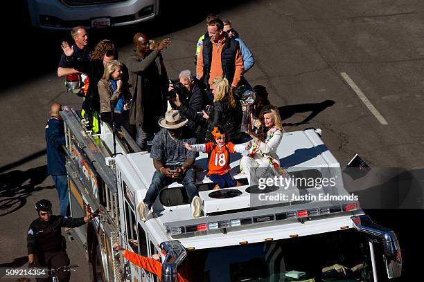 Annabel Bowlen holds the Lombardi Trophy while riding with Super Bowl MVP Von Miller of the Denver Broncos along with Demarcus Ware, #18 Peyton...