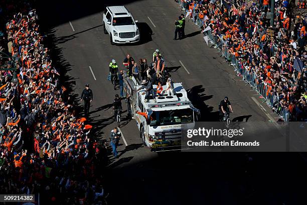 Annabel Bowlen holds the Lombardi Trophy while riding with Super Bowl MVP Von Miller of the Denver Broncos along with Demarcus Ware, #18 Peyton...