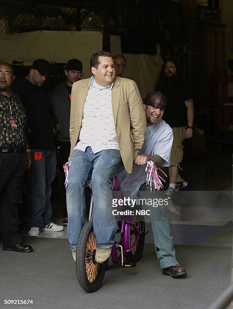 Episode 2948 -- Pictured: TV personalities Ross Mathews and Jesse James ride a bike on june 9, 2005 --