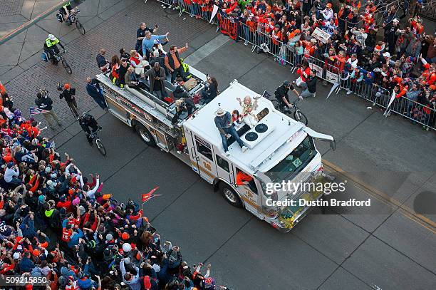 Broncos owner Pat Bowlen's wife, Annabel Bowlen, rides a Denver Fire Department fire truck with Von Miller, Peyton Manning, DeMarcus Ware, and the...