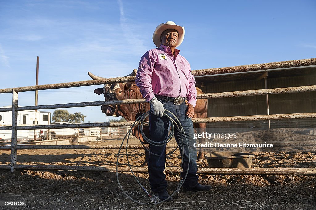 Portrait of owner Julio Moreno posing with Bushwacker during photo