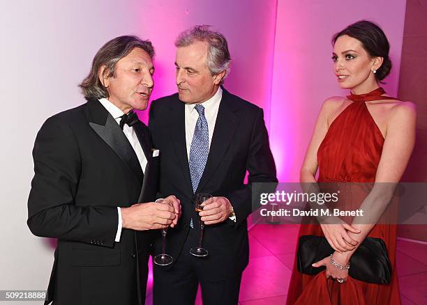 Leon Max, Viscount William Astor and Yana Max attend a private view of "Vogue 100: A Century of Style" hosted by Alexandra Shulman and Leon Max at...