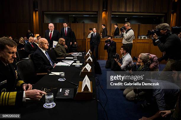 Director of National Intelligence James Clapper and other witnesses take their seat before the Senate Intelligence Committee hearing at the Hart...