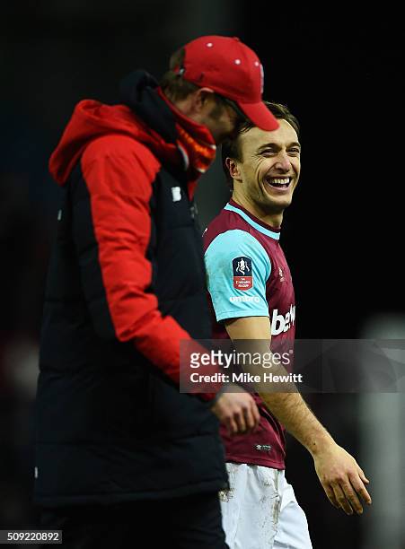 Mark Noble of West Ham United jokes with Jurgen Klopp manager of Liverpool after the Emirates FA Cup Fourth Round Replay match between West Ham...