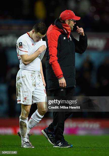 Brad Smith of Liverpool and Jurgen Klopp manager of Liverpool look dejected in defeat after the Emirates FA Cup Fourth Round Replay match between...