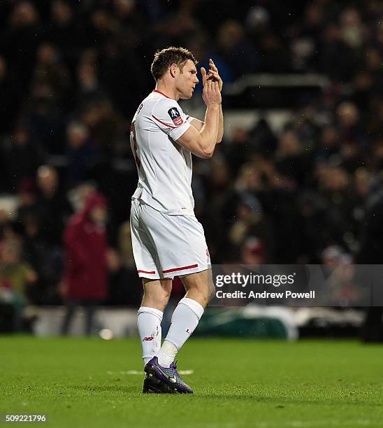 James Milner of Liverpool shows his appreciation to the fans at the end of The Emirates FA Cup Fourth Round Replay match between West Ham United and...