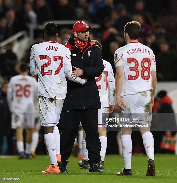 Jurgen Klopp manager of Liverpool with Divock Origi of Liverpool at the end of The Emirates FA Cup Fourth Round Replay match between West Ham United...