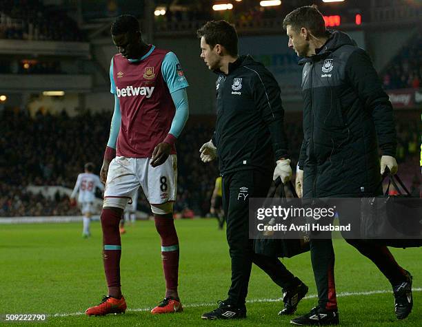 Cheikhou Kouyate of West Ham United goes off injured during the Emirates FA Cup Fourth Round Replay between West Ham United and Liverpool at Boleyn...