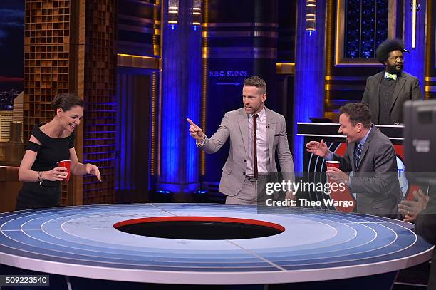 Katie Holmes, Ryan Reynolds and Jimmy Fallon play a game of "Musical Beers" during a taping of "The Tonight Show Starring Jimmy Fallon" at NBC...