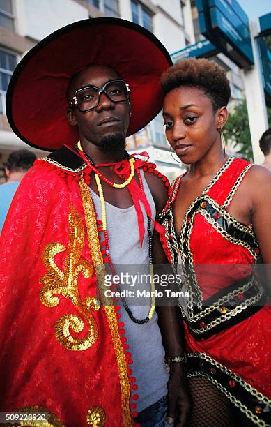 Revellers pose in dress from Angola, their native country, during Carnival celebrations at the Banda de Ipanema 'bloco', or street parade, on...